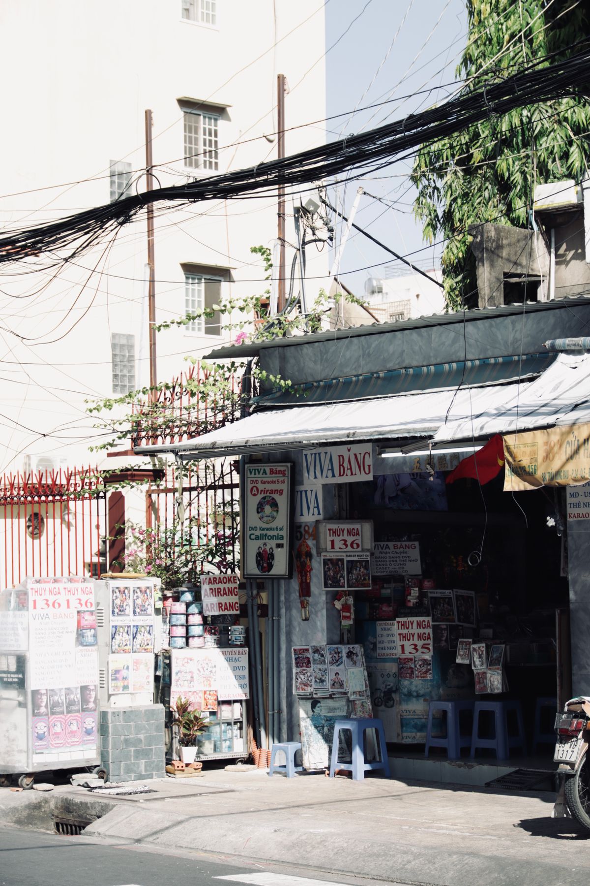 A neighbourhood shop covered with posters and street-level signs