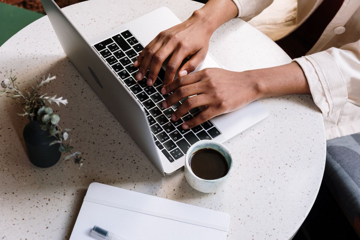Hands typing a reply on a laptop