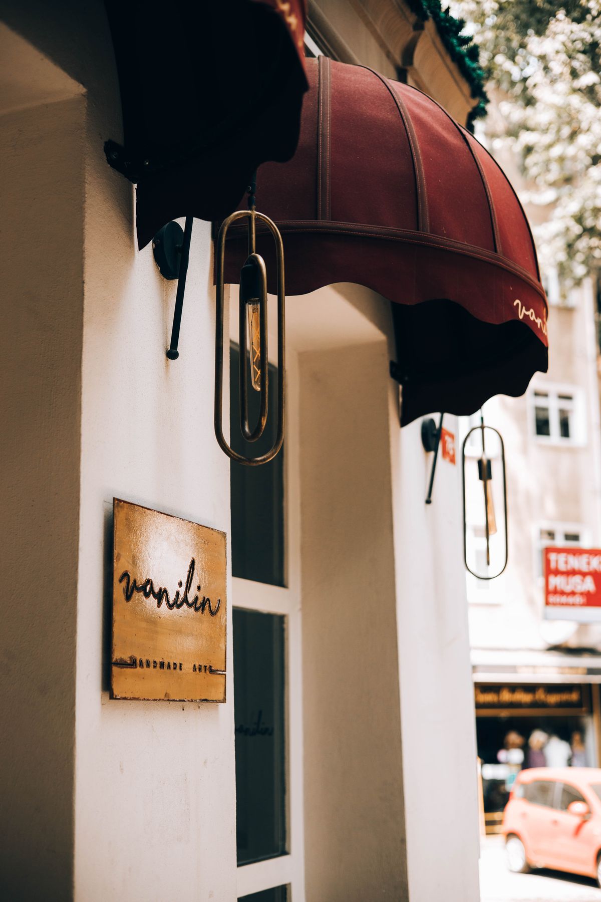 A shop awning and a hand-painted sign on a city storefront