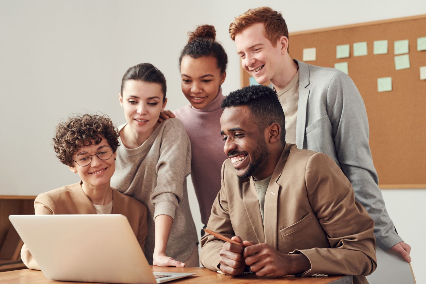 A team reviewing a plan together around a laptop